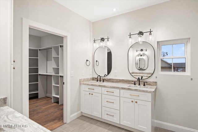 1983 Kaylee Dr, Jefferson City, TN 37760 - full bathroom with double vanity, baseboards, a spacious closet, and a sink