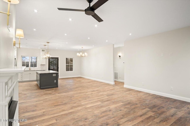1983 Kaylee Dr, Jefferson City, TN 37760 - unfurnished living room featuring recessed lighting, baseboards, ceiling fan with notable chandelier, and light wood-style floors