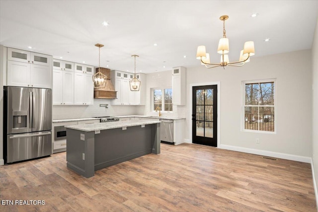 1983 Kaylee Dr, Jefferson City, TN 37760 - kitchen featuring an inviting chandelier, plenty of natural light, premium range hood, and stainless steel appliances