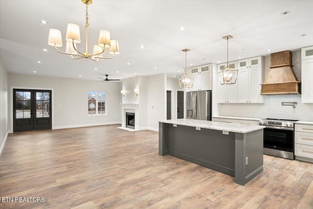 1983 Kaylee Dr, Jefferson City, TN 37760 - kitchen featuring ceiling fan with notable chandelier, premium range hood, a center island, stainless steel appliances, and recessed lighting