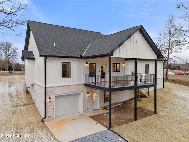 1983 Kaylee Dr, Jefferson City, TN 37760 - back of house featuring a garage, a shingled roof, driveway, and brick siding