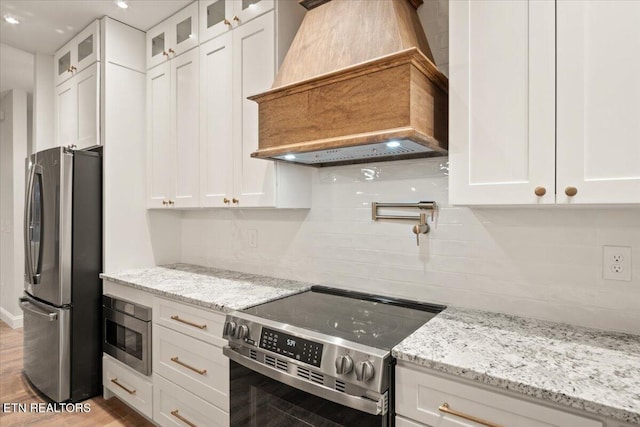 1983 Kaylee Dr, Jefferson City, TN 37760 - kitchen featuring backsplash, stainless steel appliances, white cabinets, and custom range hood
