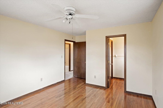 716 Lakewood Dr, Jefferson City, TN 37760 - unfurnished bedroom with ceiling fan, a walk in closet, light wood-style floors, baseboards, and a closet