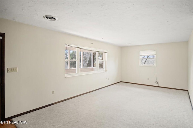 716 Lakewood Dr, Jefferson City, TN 37760 - spare room featuring baseboards, carpet, and visible vents
