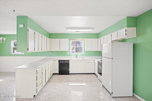 716 Lakewood Dr, Jefferson City, TN 37760 - kitchen with a sink, freestanding refrigerator, black dishwasher, and a textured ceiling