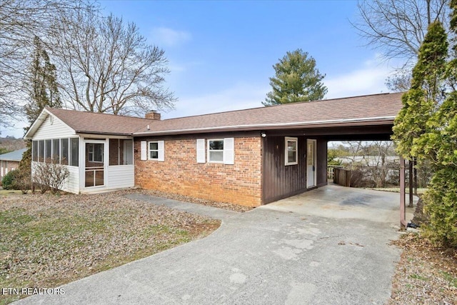 716 Lakewood Dr, Jefferson City, TN 37760 - ranch-style house featuring an attached carport, a chimney, a sunroom, brick siding, and concrete driveway