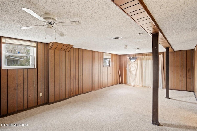 716 Lakewood Dr, Jefferson City, TN 37760 - basement featuring a ceiling fan, a textured ceiling, wood walls, and light carpet