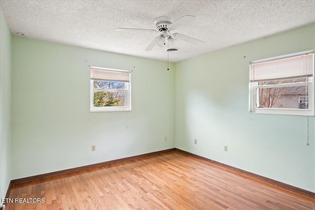 716 Lakewood Dr, Jefferson City, TN 37760 - empty room with a ceiling fan, a textured ceiling, wood finished floors, and a wealth of natural light