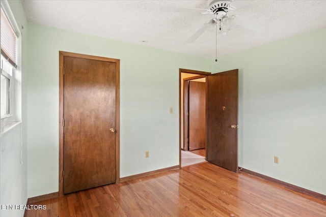716 Lakewood Dr, Jefferson City, TN 37760 - unfurnished bedroom featuring a textured ceiling, baseboards, a closet, and light wood-style floors