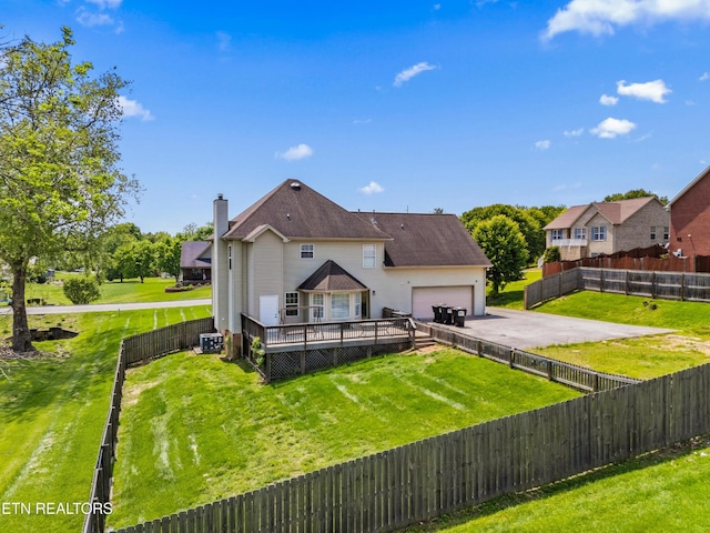 7424 Castlegate Blvd, Knoxville, TN 37918 - back of property with aphalt driveway, a garage, a wooden deck, a fenced backyard, and a chimney