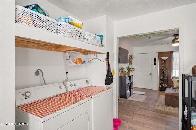 washroom featuring a ceiling fan, laundry area, washer and clothes dryer, and wood finished floors