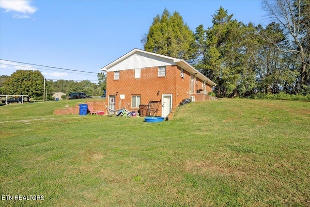 view of home's exterior featuring a yard and brick siding