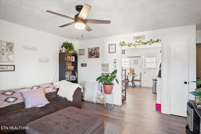 living area with ceiling fan and wood finished floors