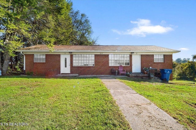 single story home with a front lawn and brick siding