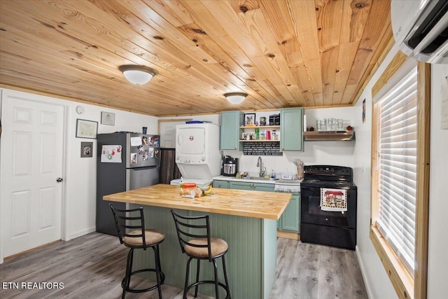 kitchen with stacked washer and clothes dryer, butcher block countertops, wood ceiling, black electric range, and green cabinets