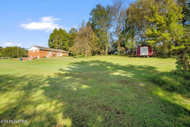 view of yard featuring a shed and an outbuilding