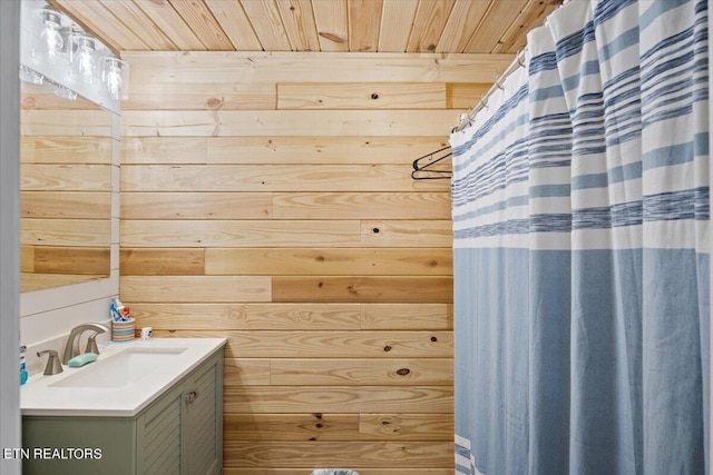 bathroom featuring wooden walls, vanity, and wooden ceiling
