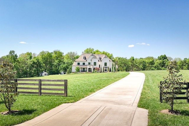 view of front of home featuring fence and a front yard