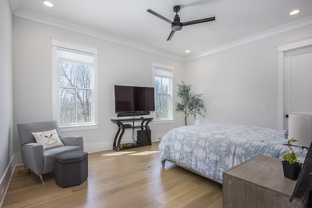 bedroom featuring crown molding, multiple windows, and wood finished floors