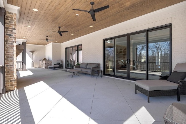 view of patio with outdoor lounge area and a ceiling fan