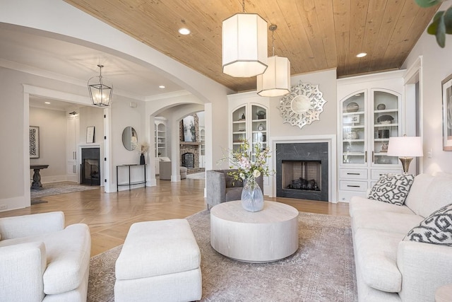 living area with recessed lighting, wooden ceiling, built in features, and a fireplace