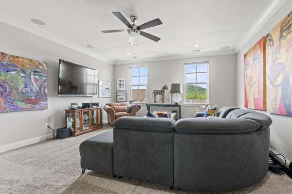 6209 Tall Timbers Rd, Franklin, TN 37067 - carpeted living area with crown molding, baseboards, and ceiling fan