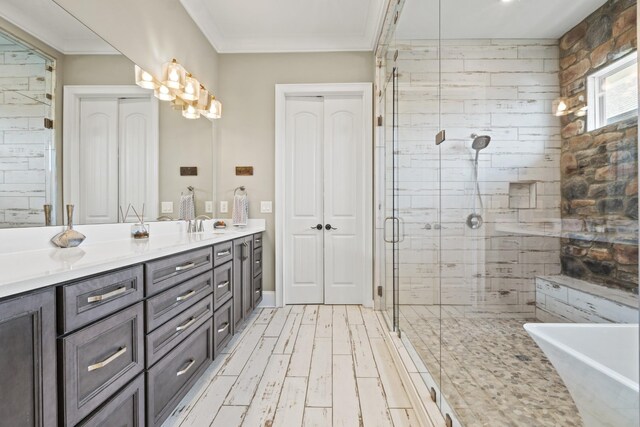 6209 Tall Timbers Rd, Franklin, TN 37067 - bathroom with double vanity, wood finished floors, a stall shower, a soaking tub, and crown molding