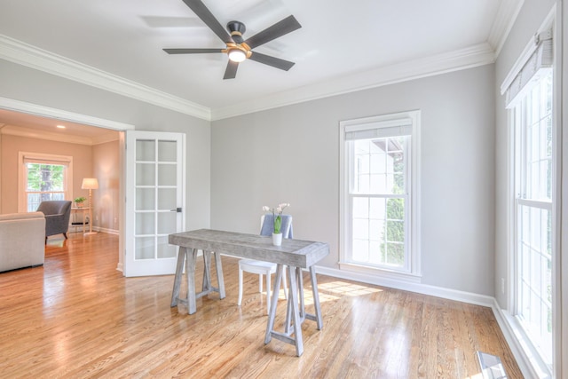 office area with baseboards, ornamental molding, a ceiling fan, and light wood finished floors