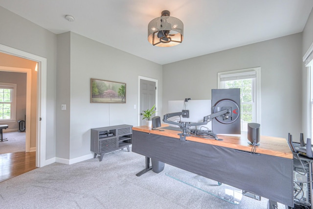 carpeted home office featuring baseboards and a healthy amount of sunlight