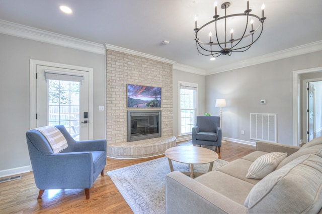 living room with light wood-style flooring, a chandelier, and visible vents