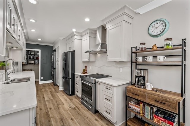 8542 Sawyer Brown Rd, Nashville, TN 37221 - kitchen with crown molding, stainless steel range with electric cooktop, a sink, freestanding refrigerator, and wall chimney exhaust hood