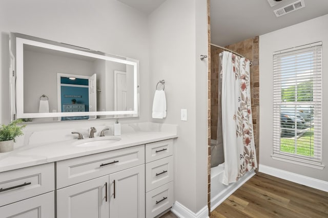 8542 Sawyer Brown Rd, Nashville, TN 37221 - full bathroom with baseboards, vanity, wood finished floors, and visible vents