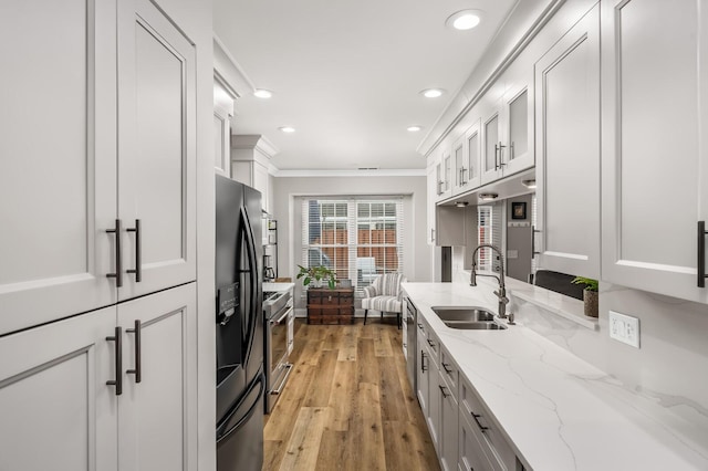 8542 Sawyer Brown Rd, Nashville, TN 37221 - kitchen featuring ornamental molding, recessed lighting, a sink, light wood finished floors, and stainless steel appliances