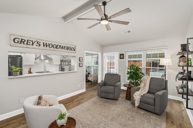 8542 Sawyer Brown Rd, Nashville, TN 37221 - sitting room featuring visible vents, wood finished floors, baseboards, ceiling fan, and vaulted ceiling with beams