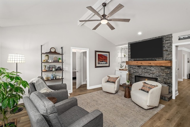 8542 Sawyer Brown Rd, Nashville, TN 37221 - living area with a ceiling fan, a brick fireplace, wood finished floors, baseboards, and lofted ceiling with beams