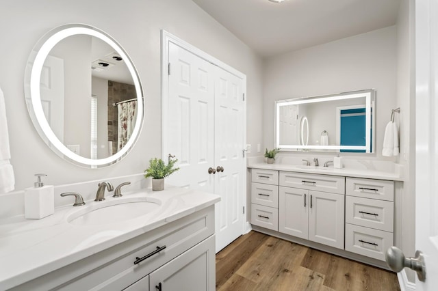 8542 Sawyer Brown Rd, Nashville, TN 37221 - full bath featuring two vanities, a sink, and wood finished floors