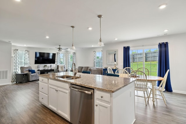 kitchen featuring stainless steel dishwasher, open floor plan, a healthy amount of sunlight, and recessed lighting