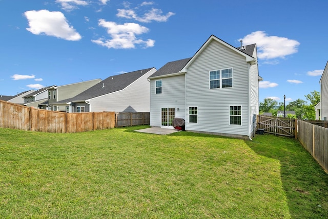 rear view of property with a fenced backyard, a patio, and a lawn