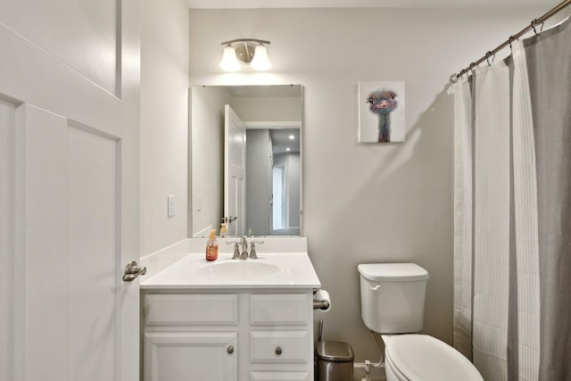 bathroom featuring vanity, toilet, and a shower with shower curtain