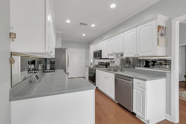 13 Hosier Ct, Lebanon, TN 37087 - kitchen featuring stainless steel appliances, a sink, ornamental molding, white cabinets, and recessed lighting