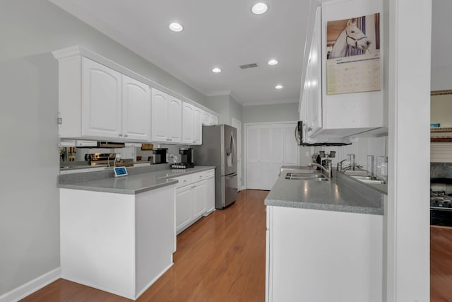 13 Hosier Ct, Lebanon, TN 37087 - kitchen with stainless steel fridge with ice dispenser, white cabinetry, crown molding, light wood finished floors, and a sink