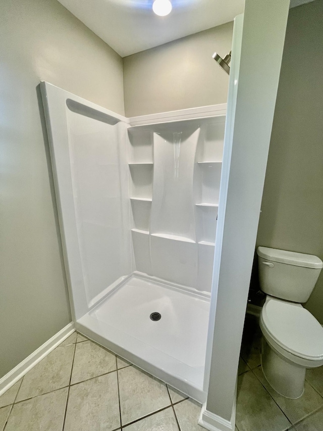 1570 Branch Dr, Lawrenceburg, TN 38464 - bathroom with baseboards, tile patterned flooring, a stall shower, and toilet