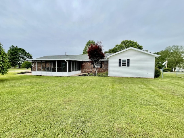 1570 Branch Dr, Lawrenceburg, TN 38464 - rear view of property with a sunroom, a lawn, and brick siding