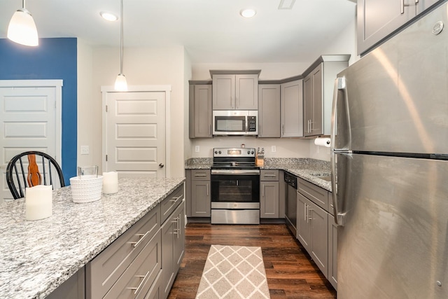 7025 Magnolia Crossings, Spring Hill, TN 37174 - kitchen with light stone counters, gray cabinetry, dark wood-style floors, and appliances with stainless steel finishes