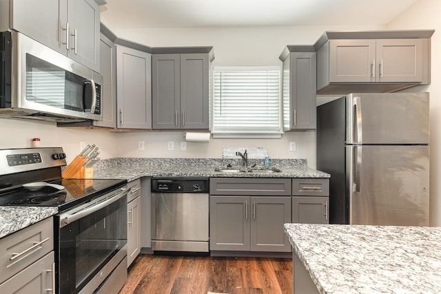 7025 Magnolia Crossings, Spring Hill, TN 37174 - kitchen featuring a sink, gray cabinets, light stone counters, dark wood-style flooring, and appliances with stainless steel finishes