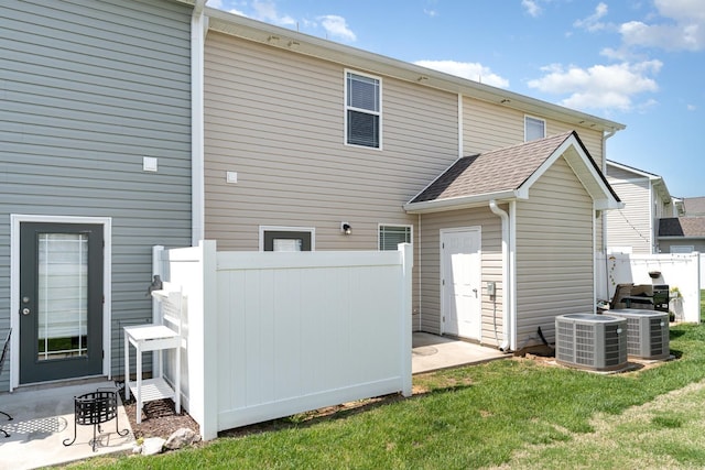 7025 Magnolia Crossings, Spring Hill, TN 37174 - back of house featuring a lawn, central air condition unit, and fence