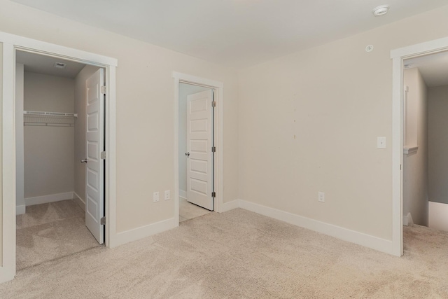 7025 Magnolia Crossings, Spring Hill, TN 37174 - unfurnished bedroom with carpet floors, a spacious closet, and a closet