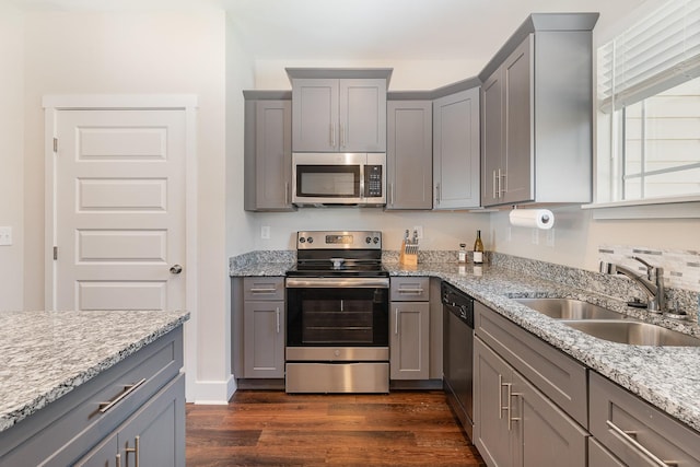 7025 Magnolia Crossings, Spring Hill, TN 37174 - kitchen featuring appliances with stainless steel finishes, gray cabinets, dark wood finished floors, and light stone countertops