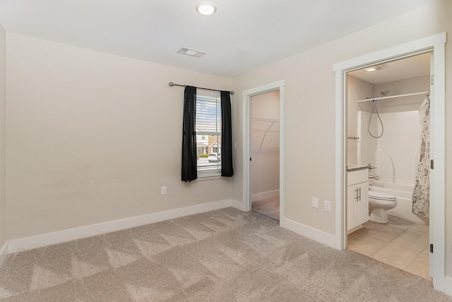 7025 Magnolia Crossings, Spring Hill, TN 37174 - unfurnished bedroom featuring light carpet, a walk in closet, a closet, and connected bathroom