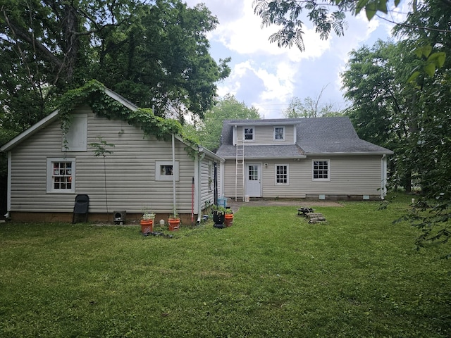 rear view of property with a yard and crawl space
